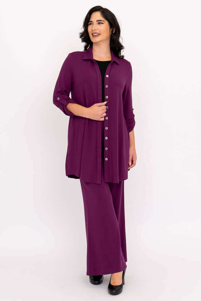 Full body view of a woman with dark hair in a purple bamboo button-up tunic set