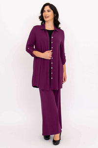 Full body view of a woman with dark hair in a purple bamboo button-up tunic set