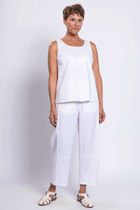 Full body view of woman in white sleeveless tank top and matching pants