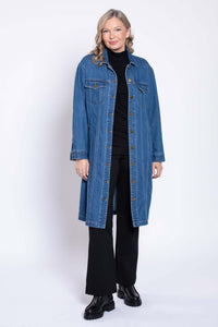 Full body view of woman modeling longline blue denim jacket with black pants and boots