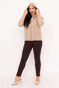 Woman wearing beige hoodie with hood up, full body view