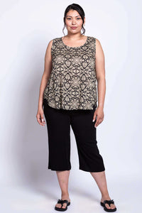 Full body shot of model wearing black and beige geometric print tank to and black capri pants