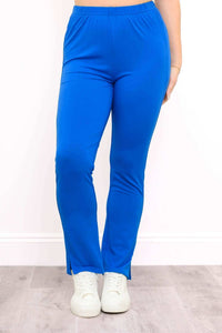 Full front view of slim blue bamboo pants styled with casual sneakers