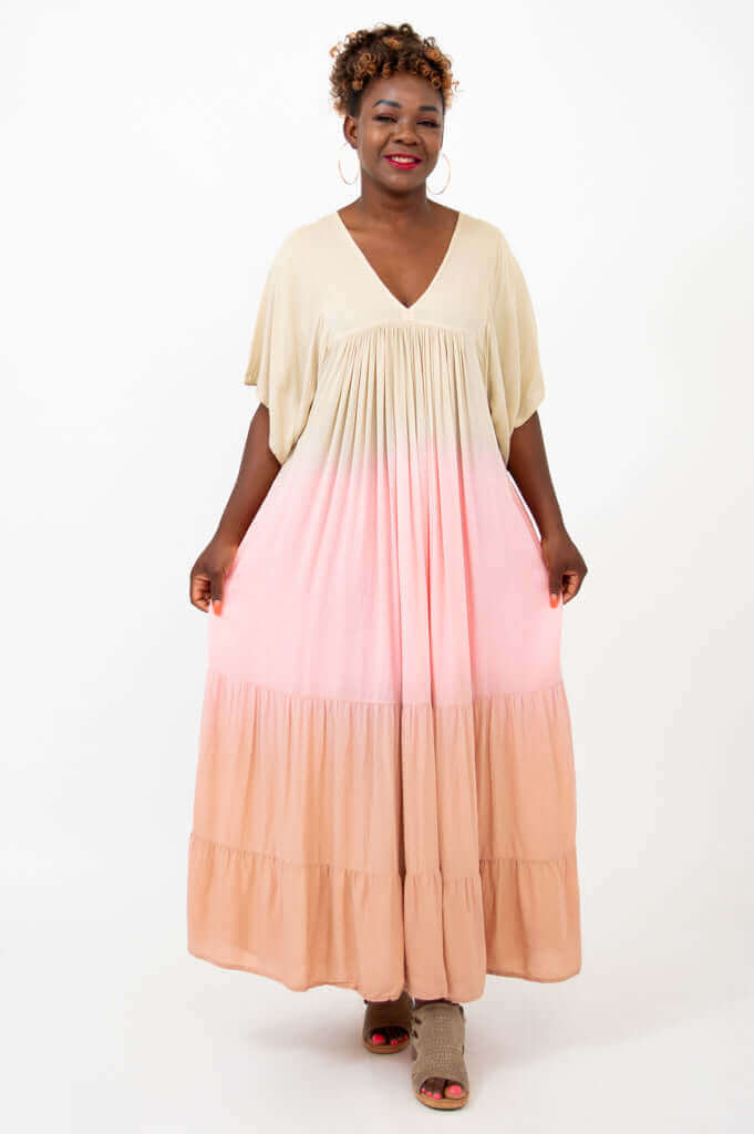 Full front view of a woman modeling a tiered ombre maxi dress in neutral and pastel shades