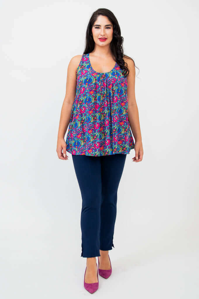 Full front view of model in Peachy pleated tank top with blue pants and purple heels