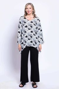 Full front view of woman modeling Dorothy black and white floral boho top and black pants