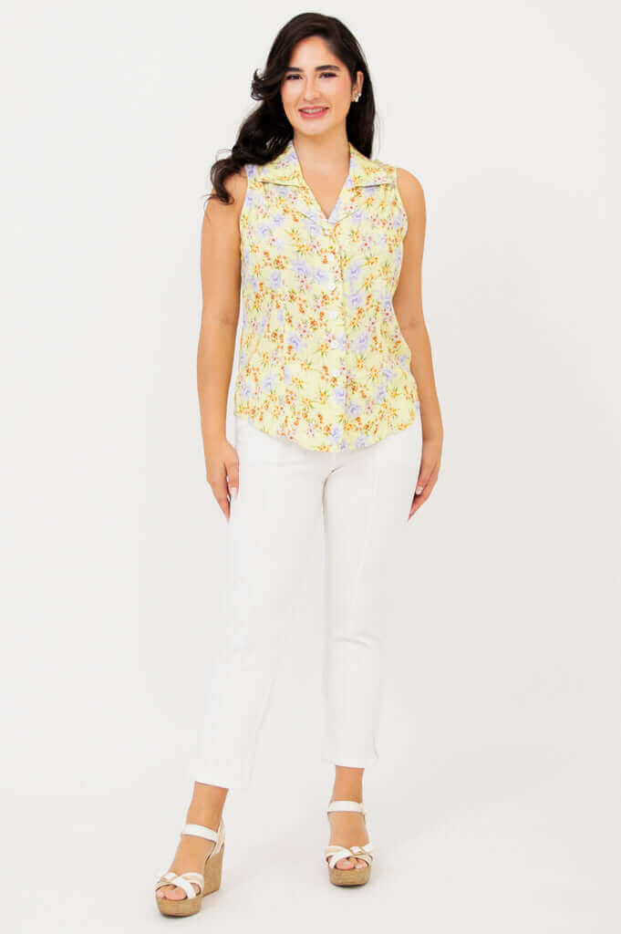 Full front view of model in Lexa yellow floral sleeveless shirt and white pants
