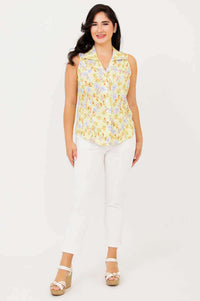 Full front view of model in Lexa yellow floral sleeveless shirt and white pants