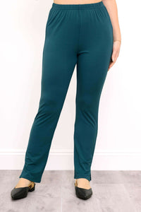 Front view of teal colour pants with ankle slit and black shoes against a white background