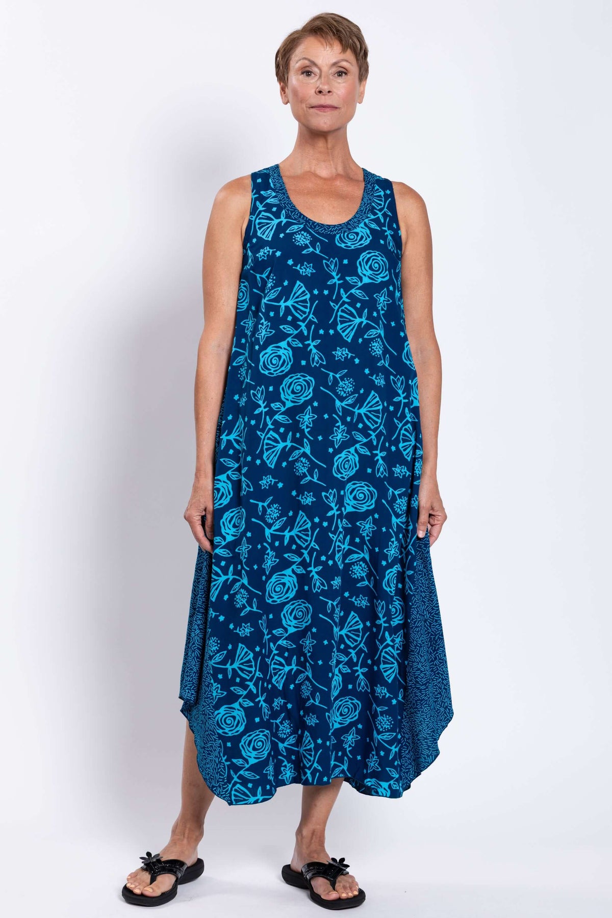 Full front view of the blue sleeveless tank dress with floral pattern, model standing