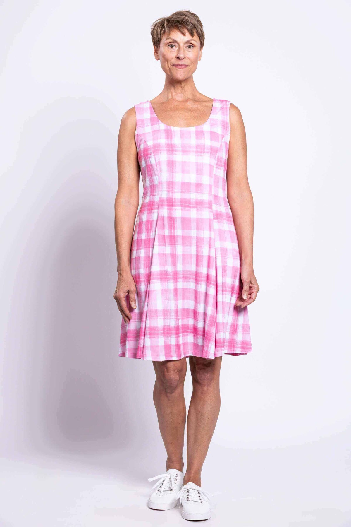 Full front view of a woman in a pink plaid scoop neck summer dress