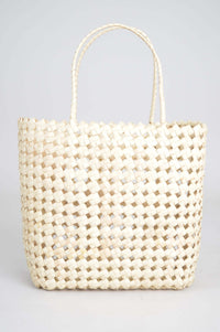 Full front view of woven rattan basket tote with handles