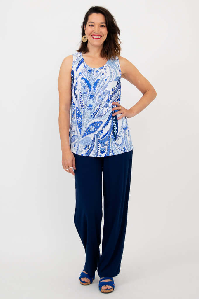 Woman showcasing indigo paisley bamboo linen tank top paired with navy pants, front view