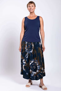 Full front view of model in navy and brown tie dye batik midi skirt, hands by sides