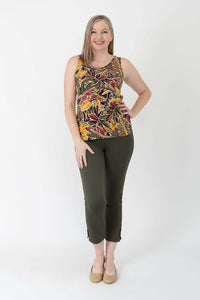 Woman in marigold batik tank top and olive pants, full front standing view