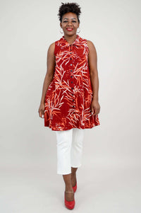 Full front view of woman in red bamboo print button-up tank and white pants