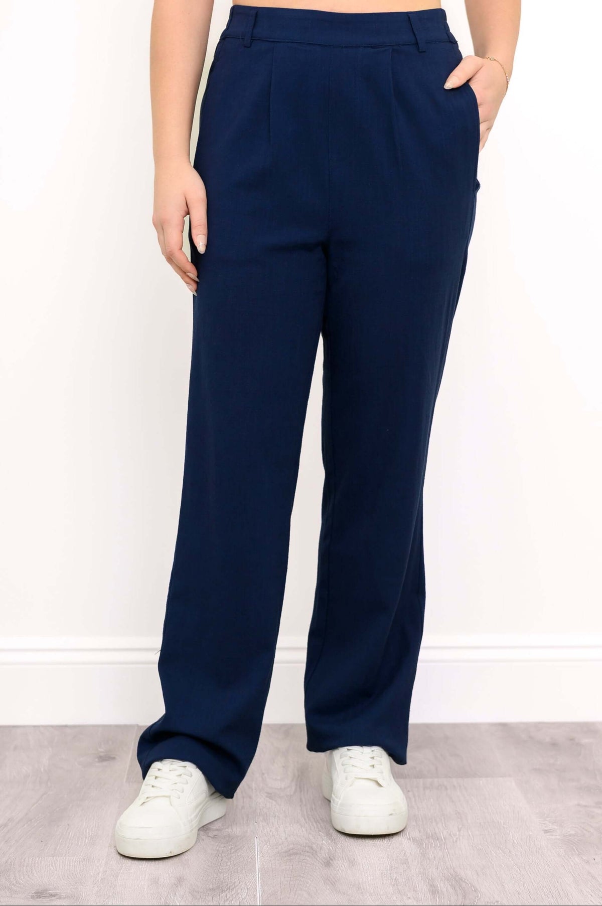 Full front view of navy Melodie pants with white sneakers