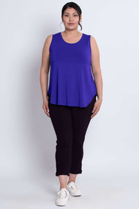 Full front view of model in grape sleeveless tank top and black pants