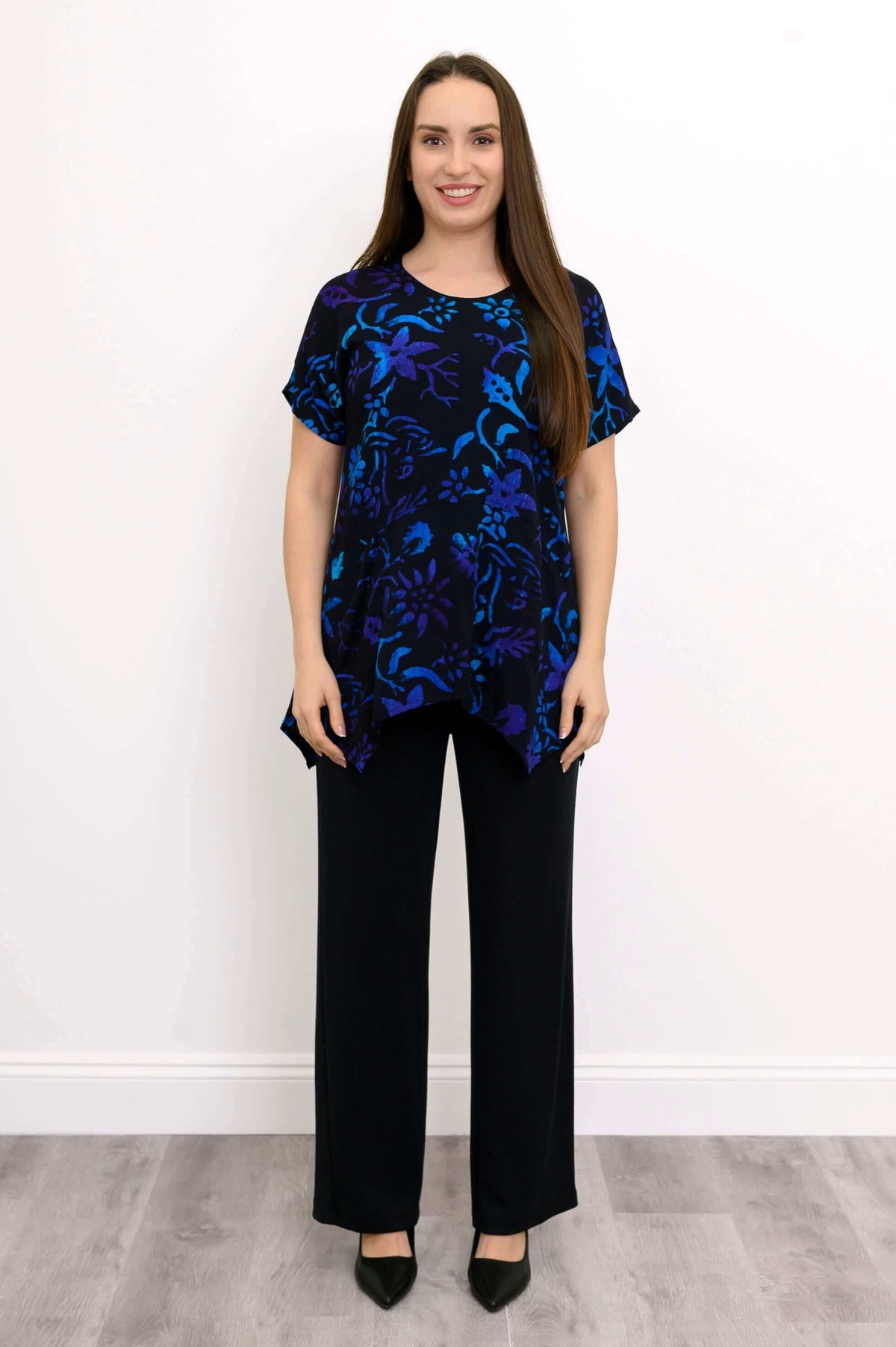 Full front view of woman in blue and purple floral print tunic top