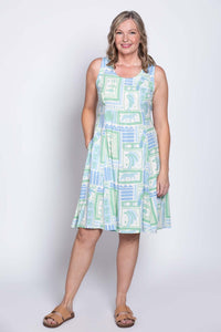 Woman in Arden dress with hands in pockets, full front view