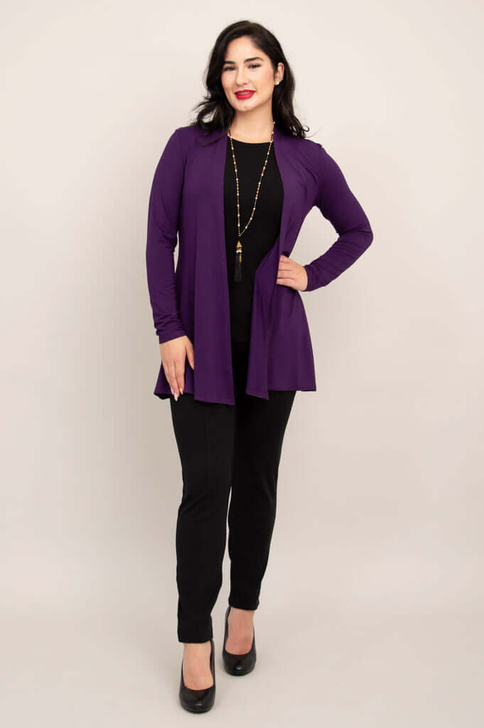 Full front view of a woman in a violet bamboo jacket with black pants and heels