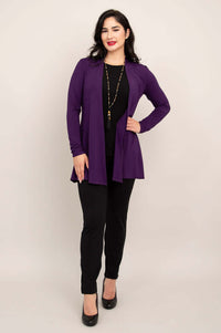 Full front view of a woman in a violet bamboo jacket with black pants and heels