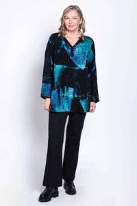 Full front view of woman in Kary Blouse with abstract blue and black batik pattern and black pants