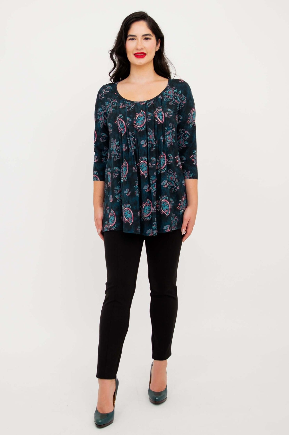 Full front view of Peyton Top in teal paisley print styled with black pants