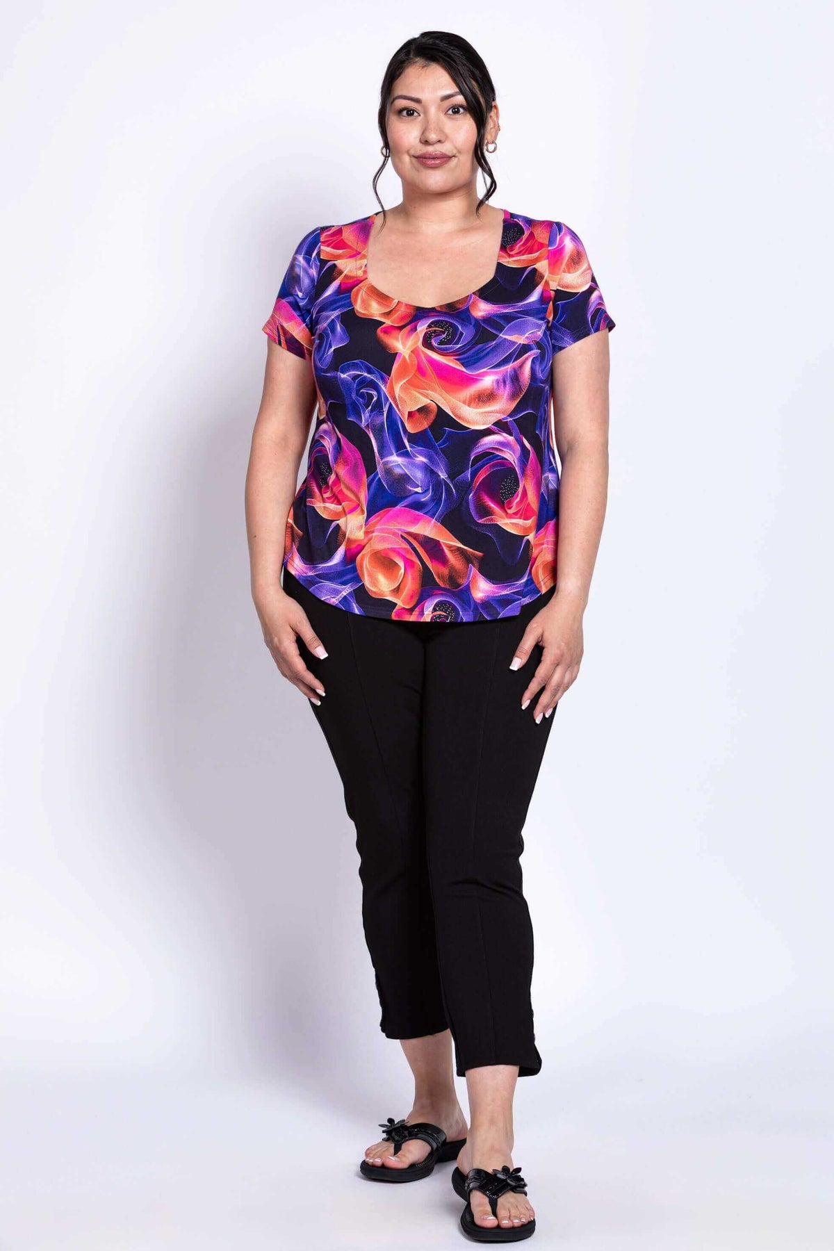Full front view of model in colorful Ritzy Short Sleeve Top and black pants