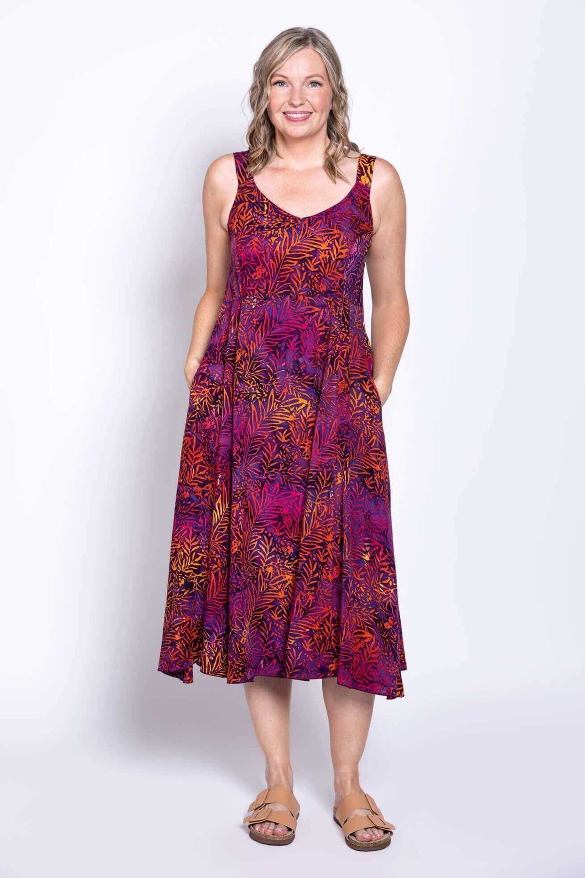 Full front view of Shauna A-line dress with model's hands in pockets, showing colorful botanical print