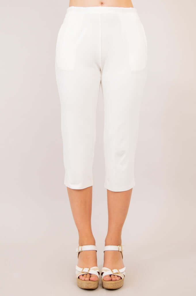 Full front view of white Susan Capri pants worn with white wedge sandals
