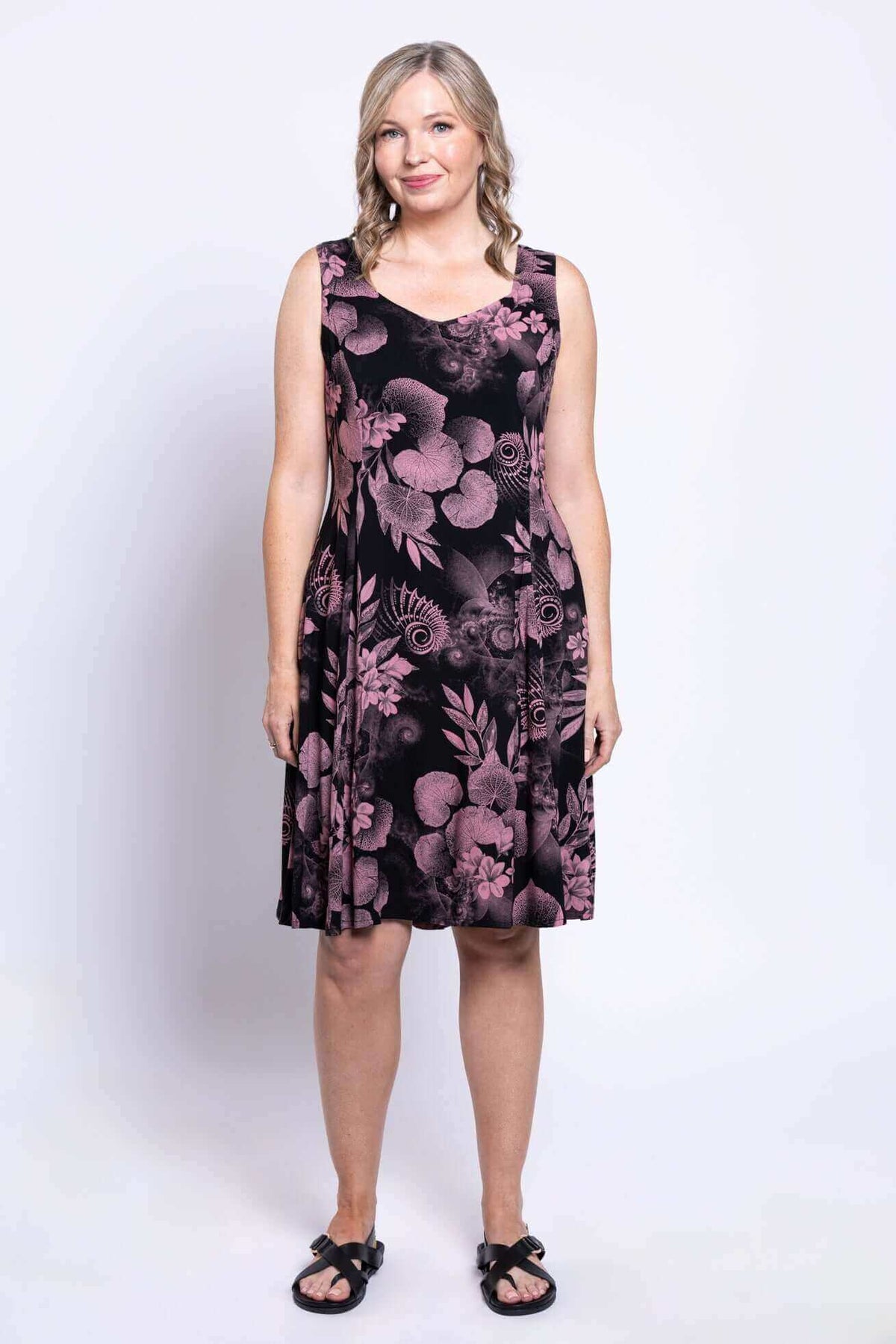 Full-length front view of woman in a black dress with pink floral print