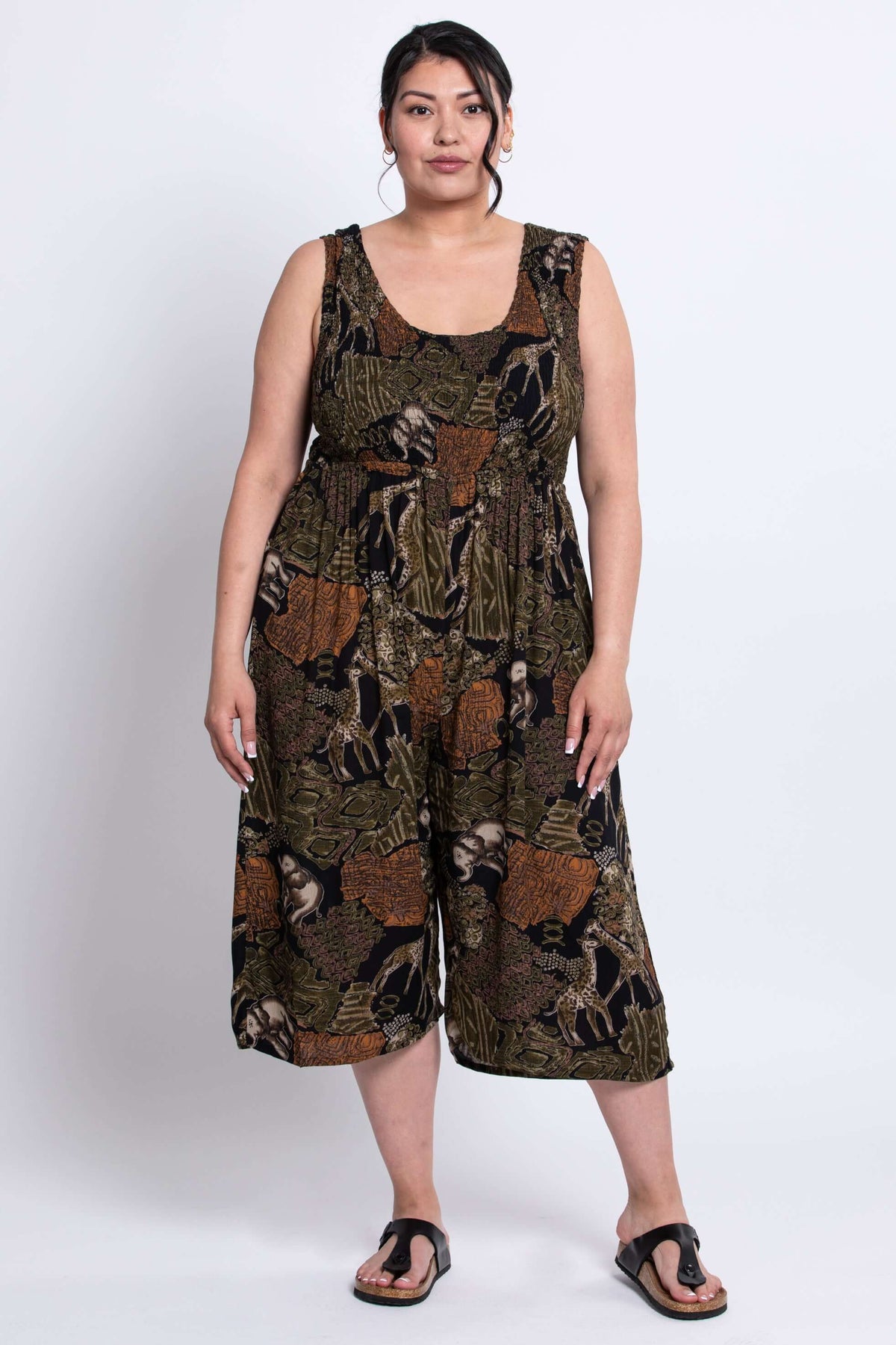 Full front view of model in a cropped, wide-leg animal print jumpsuit with sandals