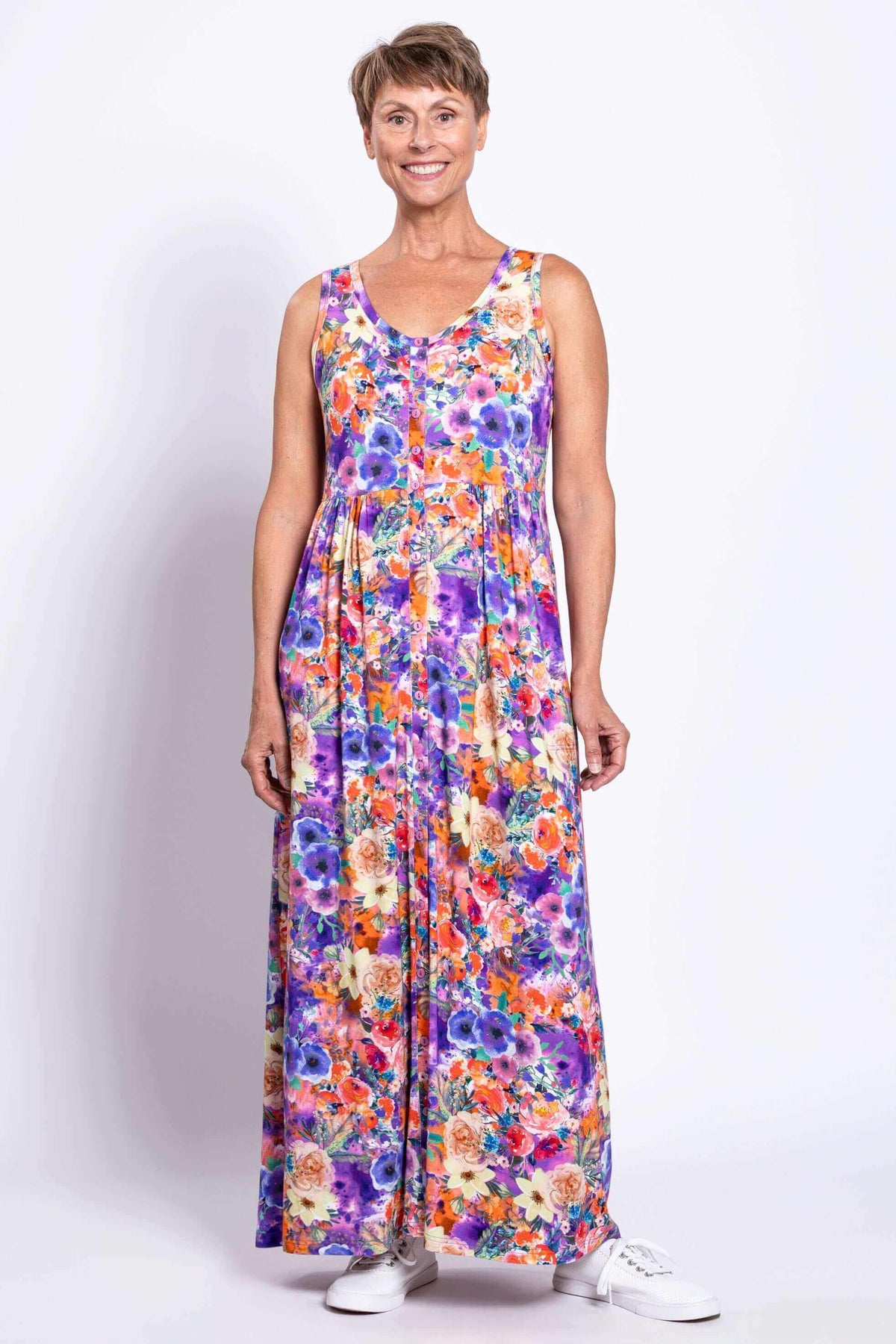 Full front view of woman in a bright floral maxi dress with button-down front