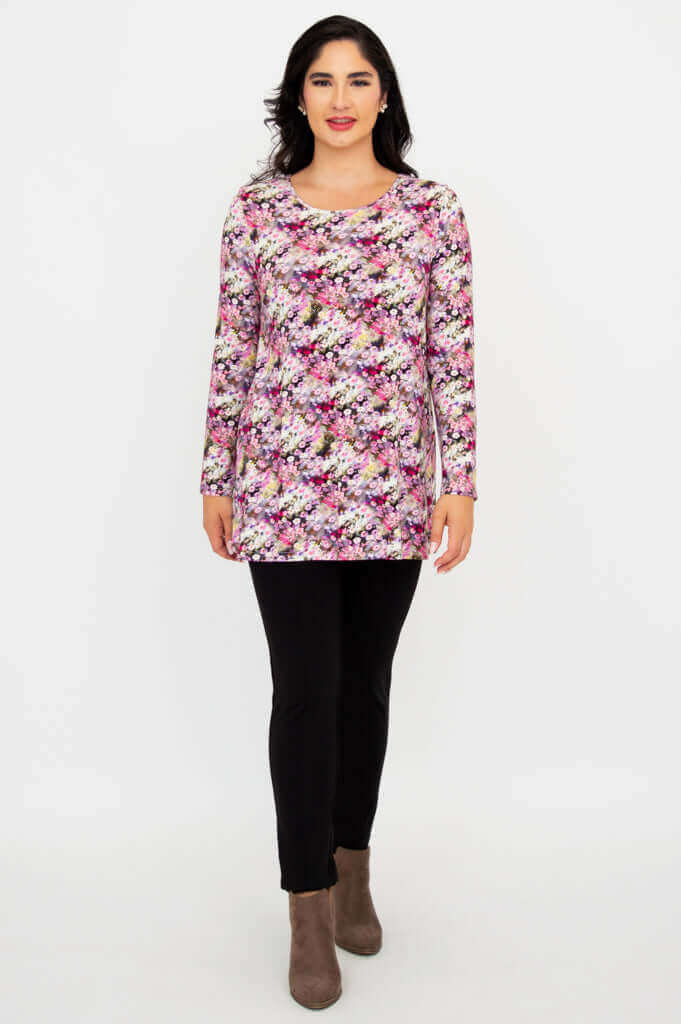 Full front view of floral long sleeve tunic top with black pants