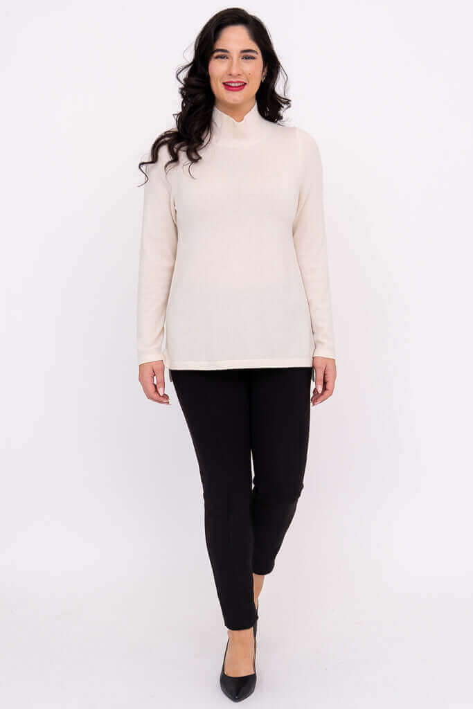 Full front view of model in cream Simmon Sweater and black pants