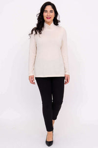 Full front view of model in cream Simmon Sweater and black pants