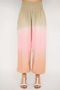 Full front view of model wearing loose, elastic-waist ombre pants in beige and pink