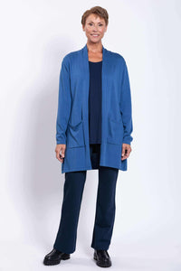 Full front view of woman smiling in a blue open-front cardigan