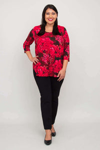Full front view of woman in fuchsia swirl bamboo top and black pants