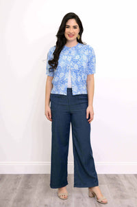 Full front view of model in Shen sky blue floral cropped cardigan with dark wide-leg pants
