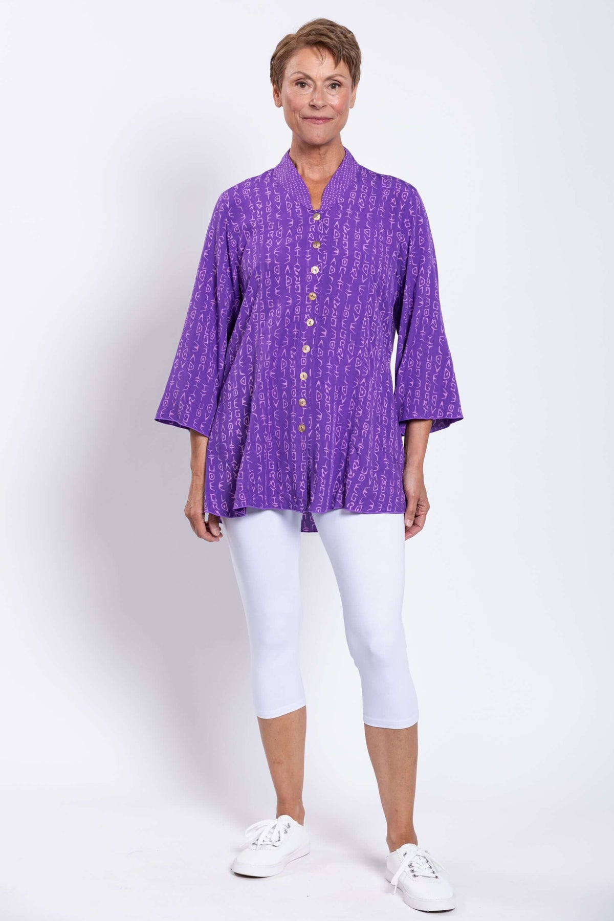 Full front view of model wearing Mar Violet Print Blouse with white leggings