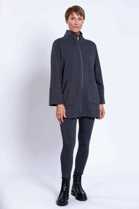 Full length front view of a woman with a zipped high collar jacket and matching leggings