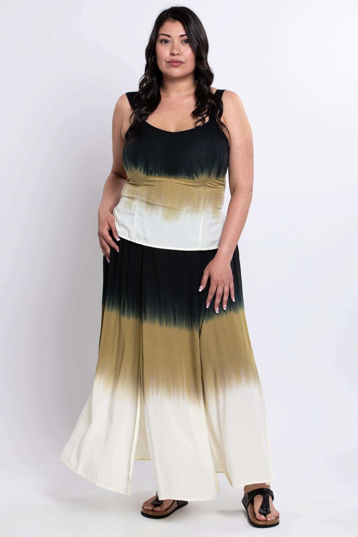 Woman modeling an ombre maxi skirt with multiple slits, showing full length, front view