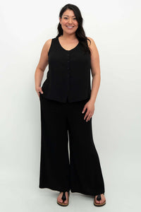 Full body view of model in black tank top and wide-leg pants