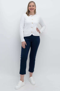 Full length view of woman in ivory gold button cardigan and navy pants