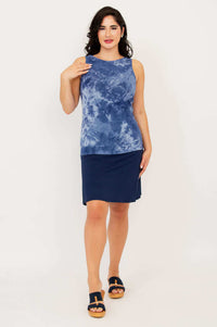 Model posing in indigo tie dye reversible bamboo tank and navy skirt, full body, front view