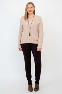 Full body view of a woman modeling the beige Davis Sweater and brown pants