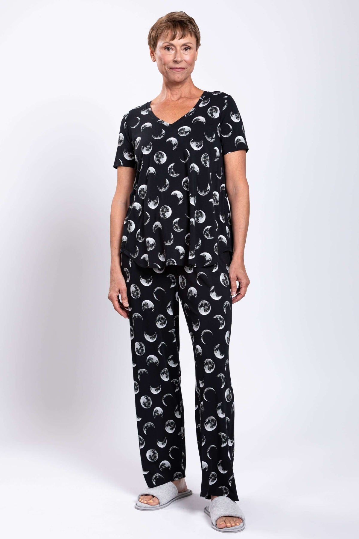 Model in relaxed fit bamboo pajama top and pants with crescent moon pattern