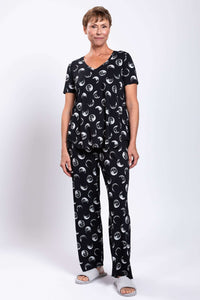Model in relaxed fit bamboo pajama top and pants with crescent moon pattern